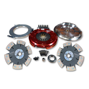 An automotive clutch assembly kit laid out on a white background, including a red pressure plate, silver flywheel, metal rings, two friction plates, small hardware, and a bearing.