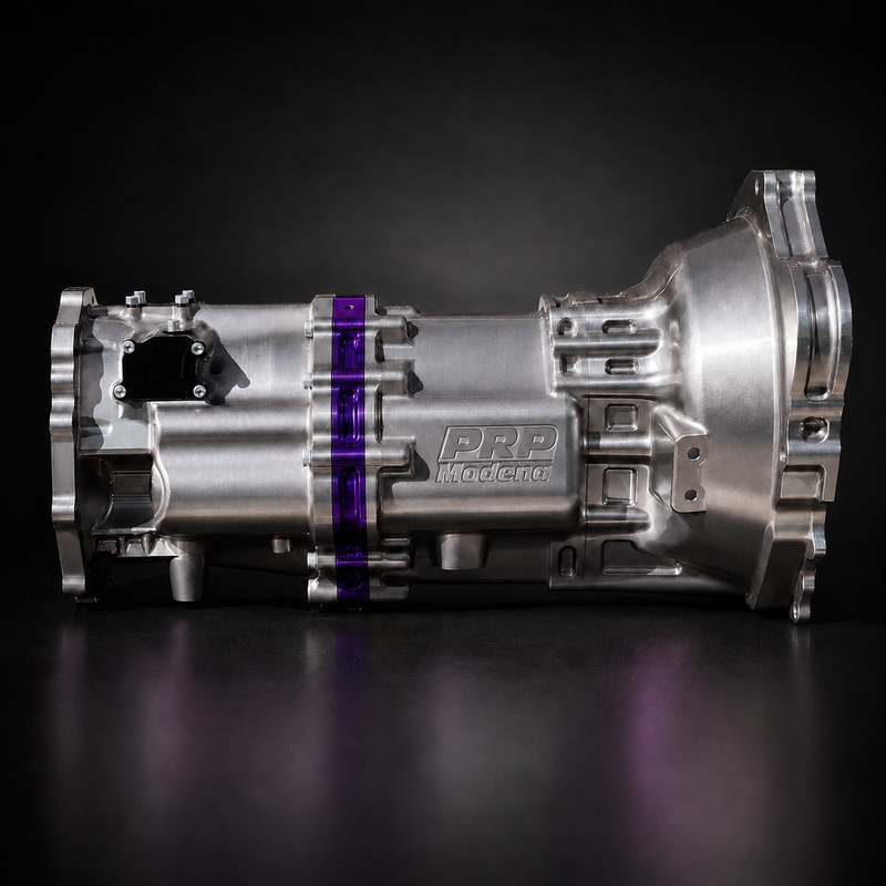 A metallic silver automatic transmission housing with a purple accent band and 'PDP Wagoneer' branding, photographed on a dark reflective studio surface.