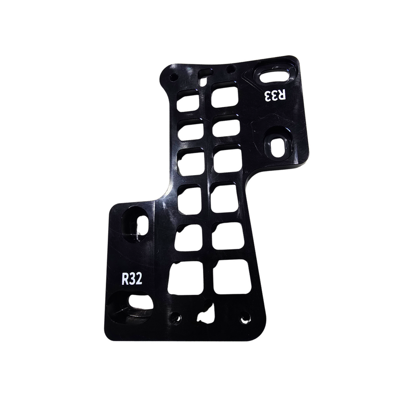 A black anodized aluminum plate or bracket with multiple cutouts and white stamped alphanumeric markings 'R32' and 'R33', shown on a plain white background.