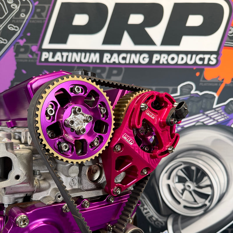 Close-up of purple and red engine components with PRP Platinum Racing Products branding in the background.